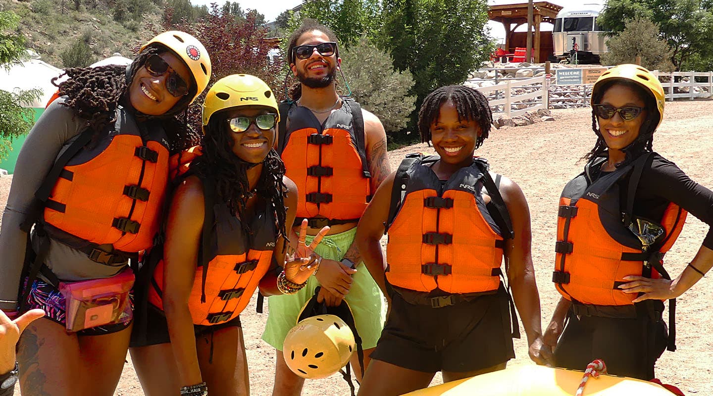 Smiling group ready for a whitewater rafting adventure